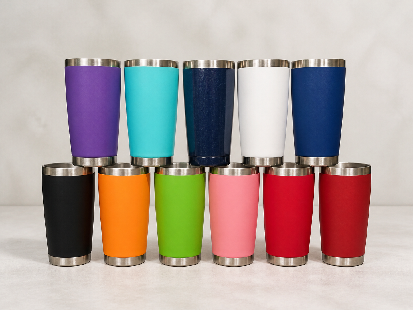 Eleven blank straight tumblers showing available colours including purple, turquoise, navy, white, black, orange, green, pink and red