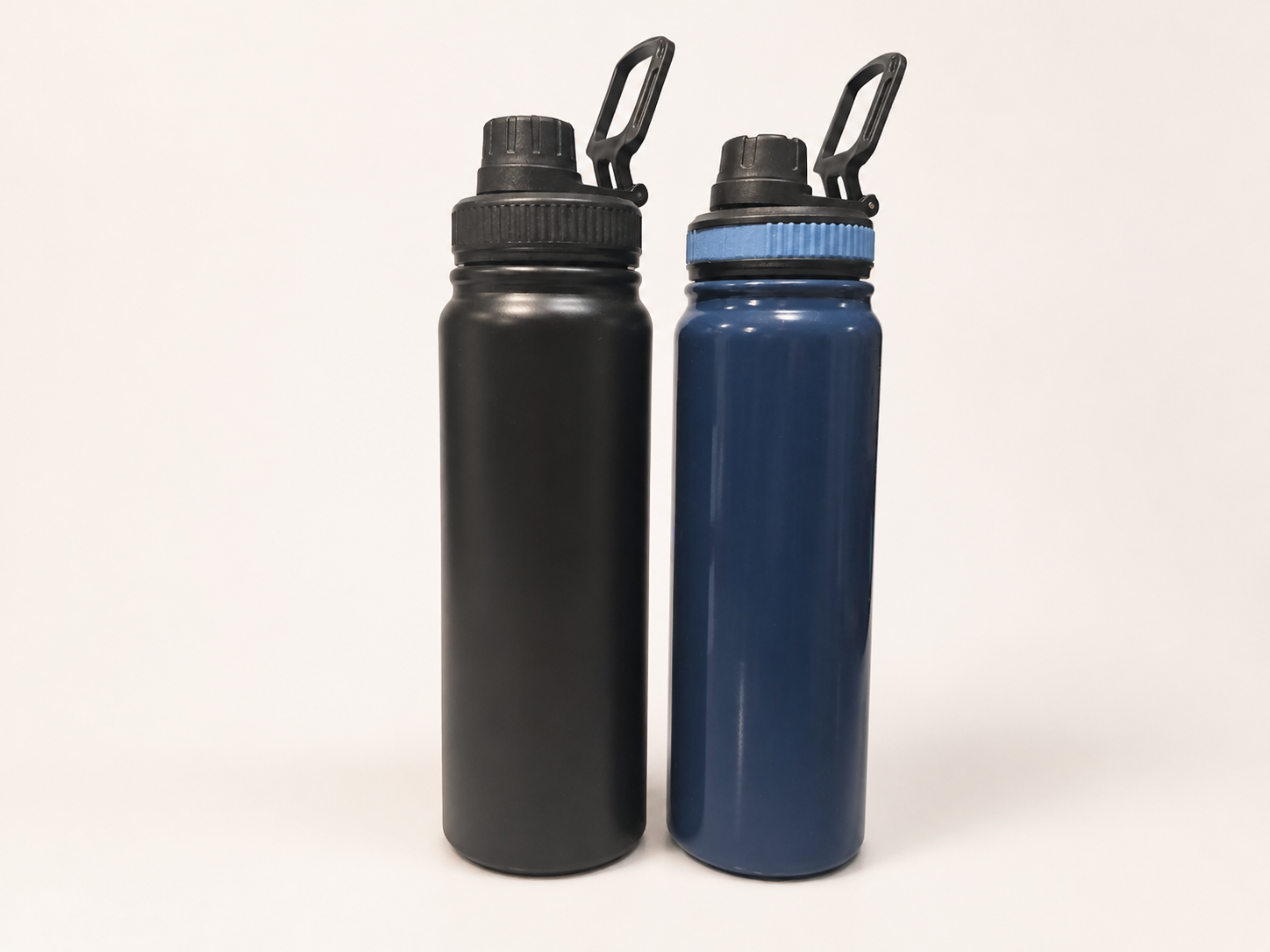 Two fully visible sports bottles in black and navy with carry-loop lids